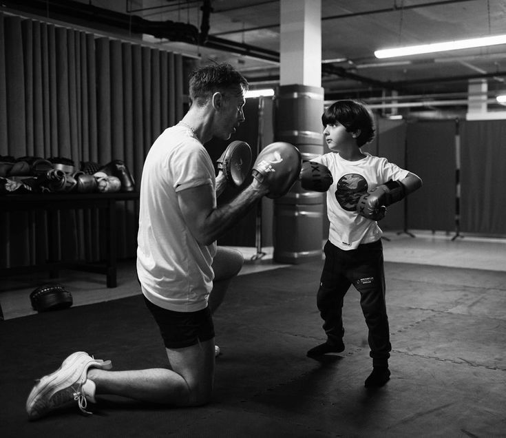 Coach teaching a young boxer at Spartan Boxing